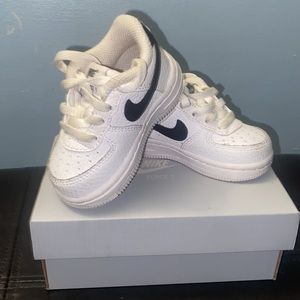 Black and white Nikes force 1